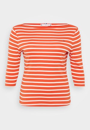 Striped top with three-quarter sleeves, made of soft orange cotton featuring wide white stripes, a boat neckline, and a small logo accent.