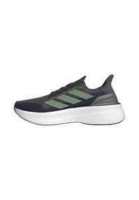 Chaussures de sport avec un dessus gris foncé texturé, des rayures vertes et une semelle rembourrée blanche. Présente un col rembourré et un design à lacets.