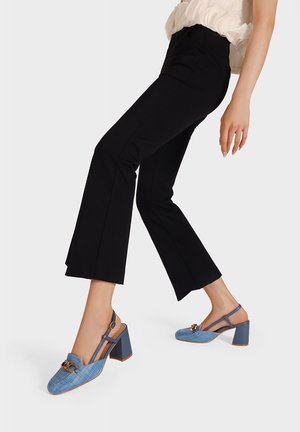 Tacchi slingback blu chiaro con tessuto testurizzato, punta quadrata e tacco a blocco. Presenta un accento decorativo con fibbia dorata.