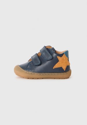 Navy blue toddler shoe with two velcro straps, a tan rubber sole, and a large tan star on the side.