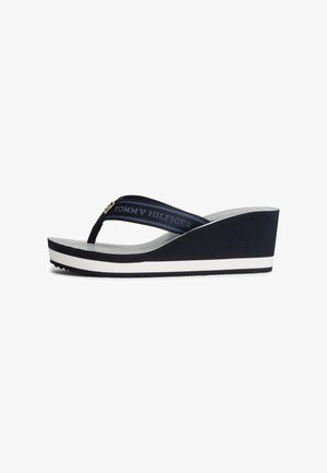 Blue wedge flip-flop with a textured strap featuring the logo. White and black striped midsole, rubber outsole for grip.