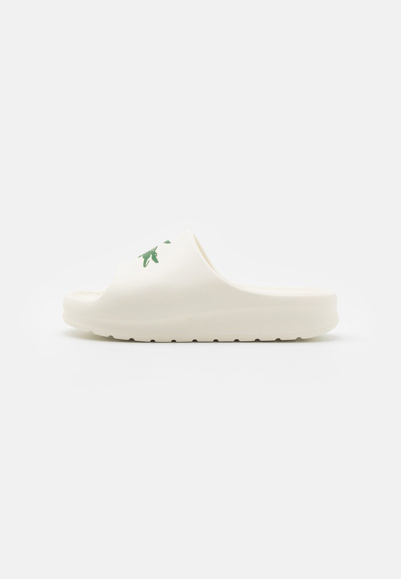 Sandal de dedo branco, moldado e sem fecho, com uma sola texturizada, apresentando um design de planta verde na parte superior. Material suave, forma arredondada.