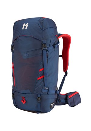 Large navy blue and red Millet hiking backpack with multiple straps, padded shoulder and waist belts, and front storage compartments.