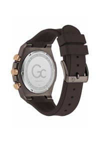 Ceas rotund cu un capac din oțel inoxidabil, accente aurii roz și o curea din silicon maro închis cu detalii texturate.