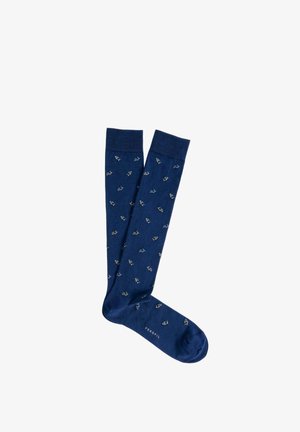 Coppia di calzini blu navy al ginocchio con piccoli motivi a ancora di colore chiaro e testo "PERFIL" vicino alle dita, su sfondo bianco.