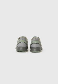 Gray athletic shoes with a mesh upper and green accents. Features a rounded toe and textured outsole for grip, designed for comfort.