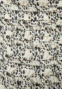 Pleated fabric in cream with a black and beige leopard print pattern; soft texture; layered design with varying shapes and lines.