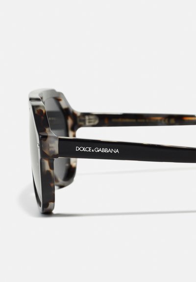 Ochelari de soare cu rame groase din material leopard, brațe negre cu branding alb "DOLCE & GABBANA" și lentile întunecate.