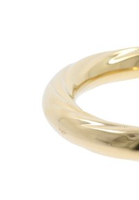 Bracciale a forma di bangle in oro placcato, con una superficie liscia e riflettente e bordi arrotondati, caratterizzato da un design continuo e senza soluzione di continuità.
