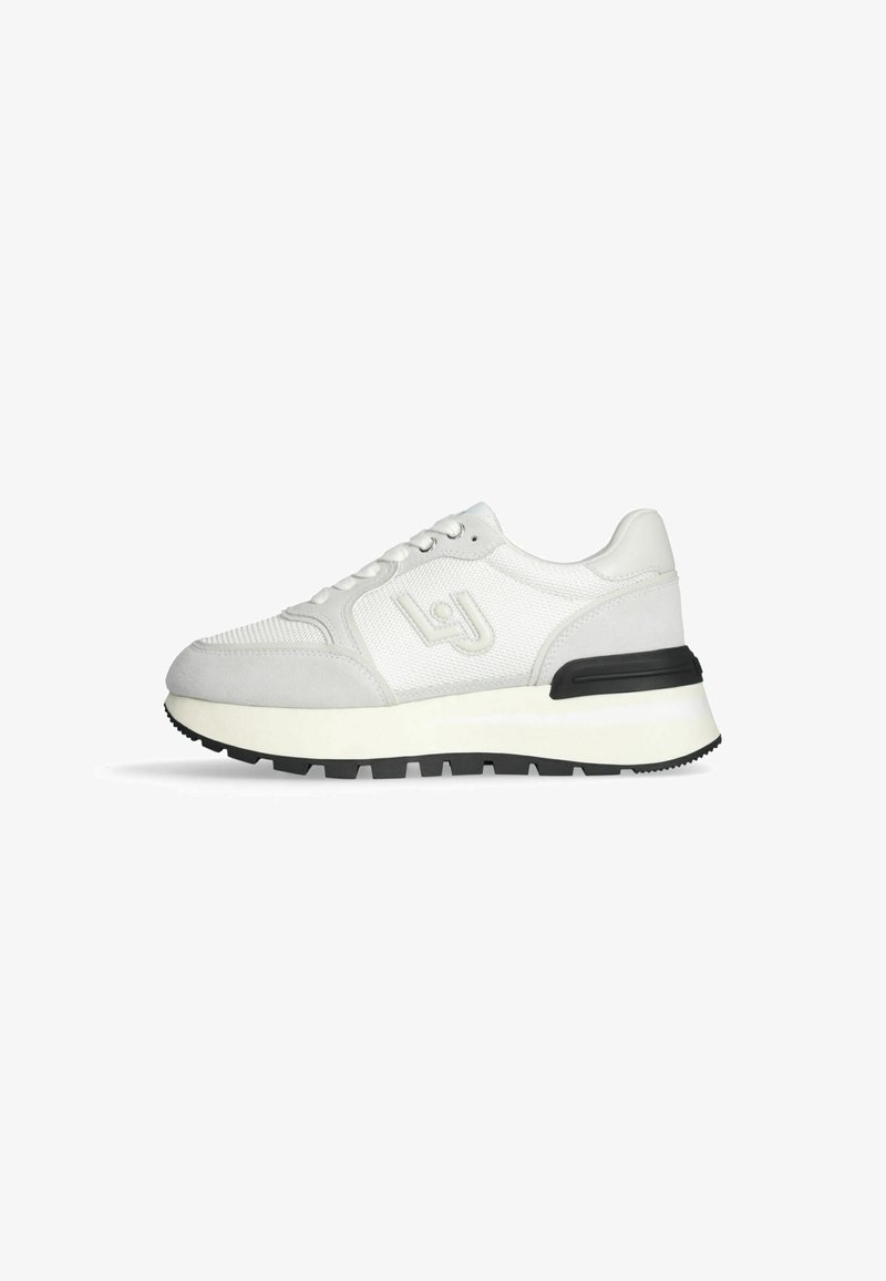 Sneaker bianca con tomaia in mesh e suede, caratterizzata da una suola nera, un'intersuola bianca e dettagli del logo discreti sul lato.