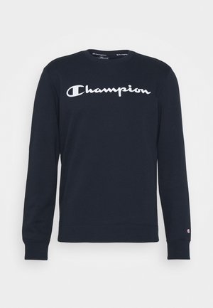 Czarna bluza z długim rękawem z białym logo "Champion" na środku klatki piersiowej i małym logo na mankiecie lewego rękawa.
