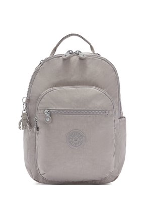 Light gray backpack made of textured fabric, featuring a rounded shape, zippered closure, front pocket, and a decorative monkey keychain.