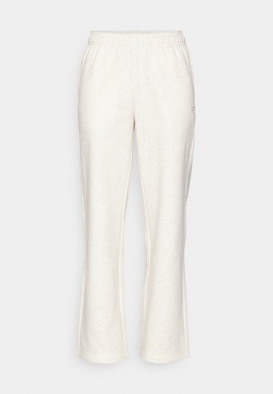Lys beige joggebukser med elastisk linning, utsvingte ben og en subtil logo på venstre front. Laget av et mykt, strukturert stoff.