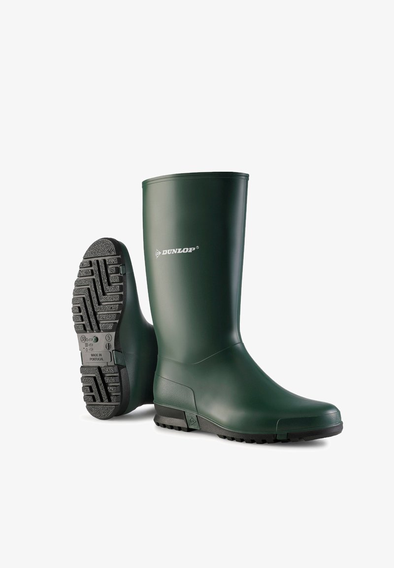 Green rubber wellington boots with a flat, textured black sole. Features raised accents and branding on the outer side. Durable and waterproof design.