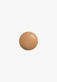 Light beige cream texture with a glossy finish, round shape, smooth surface, and subtle sheen, on a plain white background.