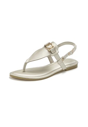 White open-toe flat sandal with thong design, adjustable ankle strap, and gold circular buckle detail on front strap.