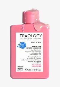 Bouteille de shampoing en plastique rose avec un capuchon à flip, arborant une étiquette blanche. Le texte inclut "Shampoing Hydra Thé Pêche" et des détails sur les ingrédients.