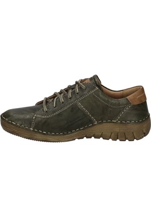 Leather lace-up shoe in dark green with contrasting light stitching, textured tan accents, and a rubber sole featuring a multi-directional tread.