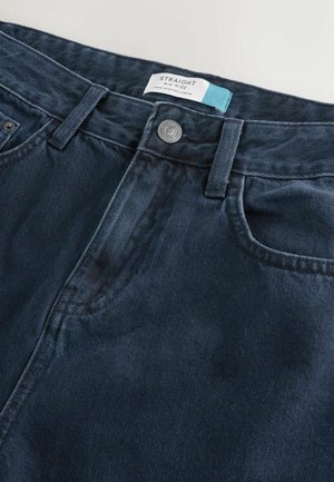Dark blue straight mid-rise jeans with a metal button and fabric label stitched inside the waistband.
