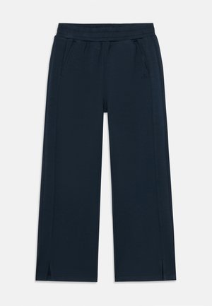 Marineblaue, weit geschnittene Hosen aus weichem Material mit elastischem Bund, seitlichen Taschen und Schlitzen am Saum für mehr Bewegungsfreiheit.
