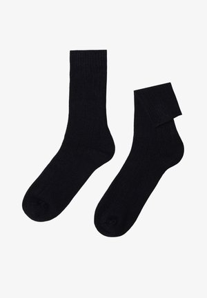 Black ribbed socks, mid-calf length, made of soft fabric with a smooth texture and reinforced toe and heel areas for durability.