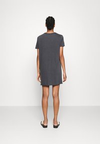 Gray cotton t-shirt dress, knee-length, short sleeves, relaxed fit, featuring a rounded neckline and a simple, unembellished design.