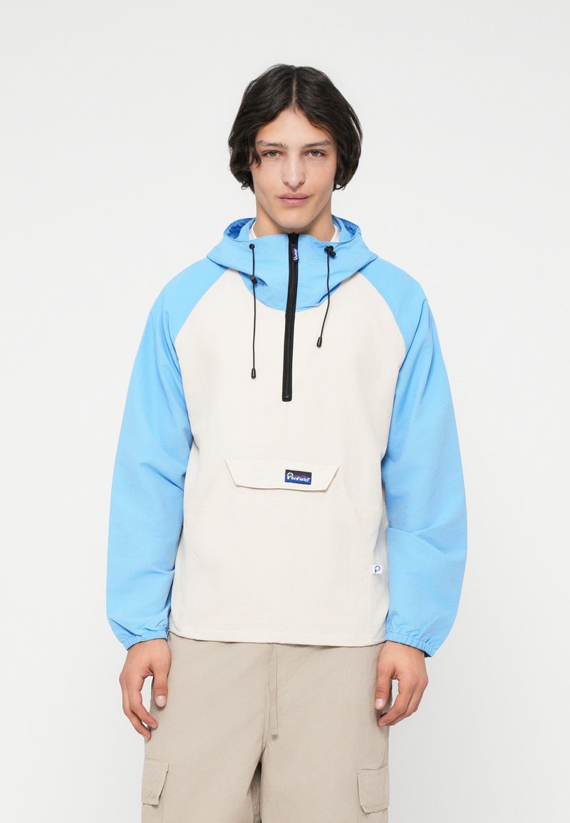 Leichte Kapuzenjacke in Beige und Blau, mit einem Reißverschluss vorne, elastischen Bündchen und einer Fronttasche mit einem Logoetikett.