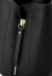 Borsa a mano nera in pelle con superficie testurizzata. Dotata di una cerniera dorata, accentuata da un tirante in pelle e dettagli di cucitura visibili.