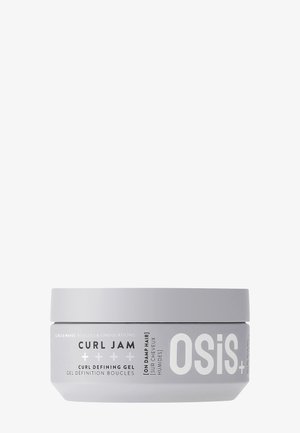 Grijze ronde pot met een witte deksel. Etiket bevat zwarte tekst met de vermelding "Curl Jam Curl Defining Gel" en "OSiS+". Gladde, matte afwerking.