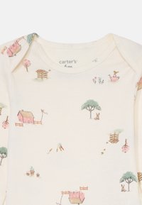 Infant bodysuit in cream with a whimsical farm scene print, featuring pastel barns, trees, rabbits, and a watering can. Cotton blend, smooth texture.
