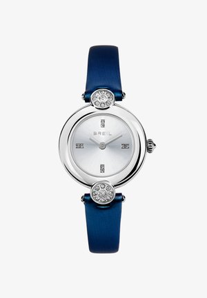 Montre Breil ronde en argent avec un bracelet bleu, des marqueurs en cristal aux positions 12, 3, 6 et 9, et des accents décoratifs en cristal au-dessus et en dessous du cadran.