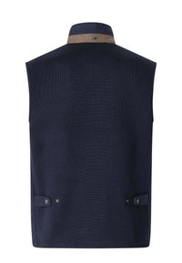 Tmavě modrá vesta bez rukávů s hnědým lemováním na límci a nastavitelné boční pásky se zapínáním na cvočky, pohled ze zad.