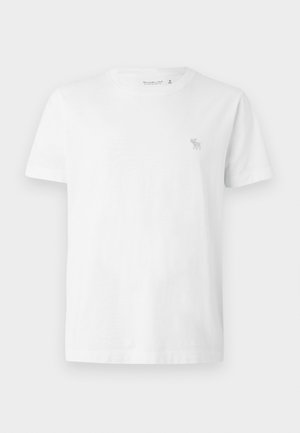 Maglietta in cotone bianco a maniche corte, girocollo, con un piccolo logo grigio ricamato sul lato sinistro del petto. Texture liscia.