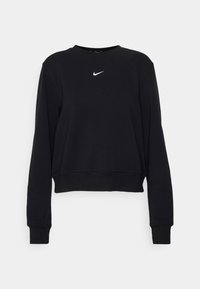 Musta lyhythihainen collegepaita, joka on valmistettu pehmeästä kankaasta. Paidassa on pitkät hihat ja pyöreä pääntie, ja rintamalla on valkoinen Nike-logo.
