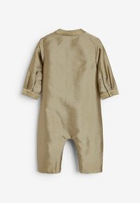 Khaki jumpsuit met een structuurpatroon, lange mouwen en knoopmanchetten. Heeft een ronde kraag en open benen voor gemakkelijke beweging.