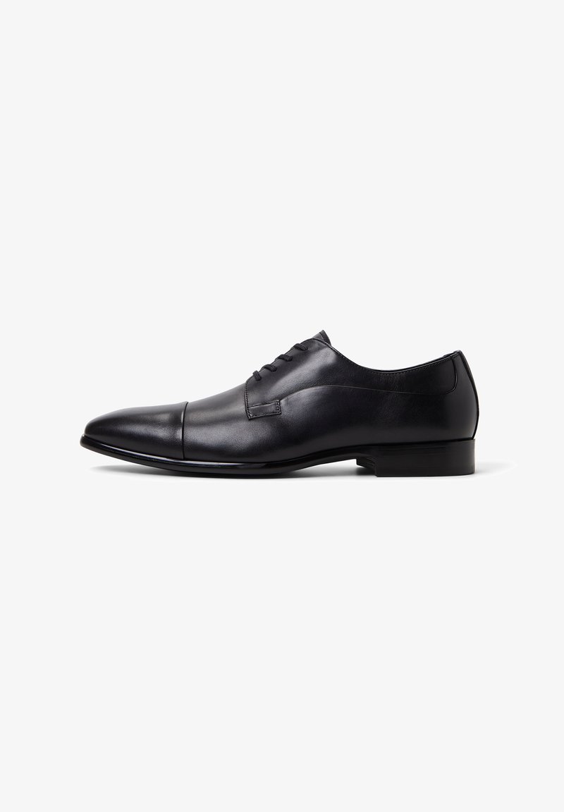 Black leather dress shoe with a polished finish, pointed toe, lace-up design, and a low, rectangular heel. Smooth texture, minimal accents.