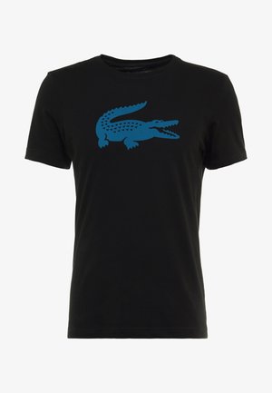 Camiseta negra de manga corta con un gran gráfico azul estilizado de cocodrilo centrado en el pecho.