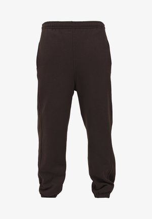Pantalons de sport noirs en tissu doux et extensible, avec une taille élastique et des poignets fuselés, présentant une texture lisse et sans éléments métalliques visibles.