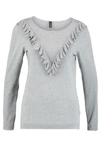Pull gris à manches longues et décolleté en V, avec un volant sur le bord du décolleté. Fabriqué en tissu tricoté doux et texturé.