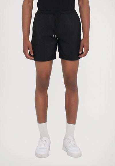 Sorte svømmetights med elastisk talje og snor. Fremstillet af let materiale, med en glat overflade og minimalistisk design.