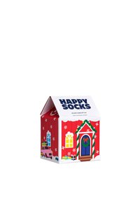 Czerwone pudełko prezentowe w kształcie domu z białymi akcentami, z drzwiami, oknami, płatkami śniegu i napisem "Happy Socks" na górze.