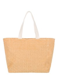 Sac fourre-tout en matériau beige texturé avec un motif répétitif, doté de poignées en tissu blanc et d'un design ouvert.