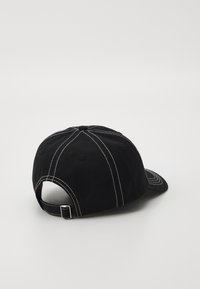 Black baseball cap with white stitching, adjustable strap at the back, rounded bill, and unstructured crown design.