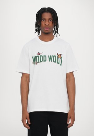 White cotton t-shirt featuring green "WOOD WOOD" text and butterfly graphics. Short sleeves, crew neck, and relaxed fit.