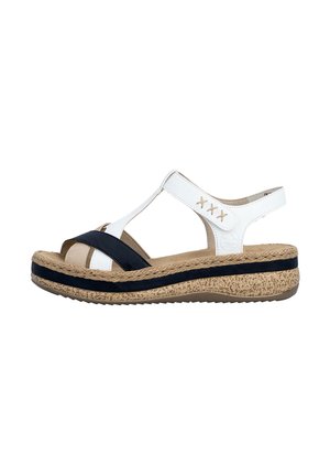 Dames open-toe sandaal met witte en zwarte bandjes, verstelbare enkelriem en een beige platformzool met textuur en zwart accent.