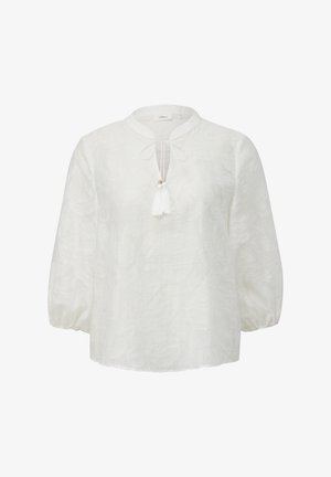 Bela bluzica z teksturiranim cvetličnim vzorcem, okroglo izrezano dekolte, in zavezovanjem spredaj, ki vključuje tudi ponjavico. Dolgi, napihnjeni rokavi.