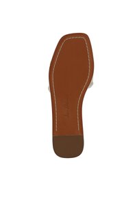 Suola di scarpa in pelle tan con tacco marrone a contrasto. Cuciture bianche contornano la suola, con un'incisione del marchio vicino al tacco.