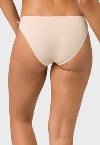 Beige, hochgeschnittener Bikini-Unterteil aus glattem Stoff mit elastischem Bund und Kontrastnähten. Nahtloses Design für ein sauberes Finish.