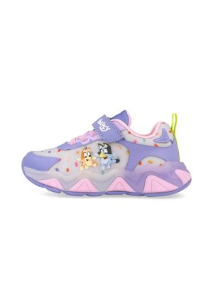 Zapatilla deportiva infantil en púrpura pastel y rosa con personajes de perros de dibujos animados y patrones de chispas de colores en el lateral, con cierre de velcro.