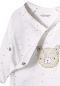 Weißer Babybody mit dezentem grünen Punktmuster, versehen mit einer beige Bärenkopf-Applikation und Druckknöpfen an der Seite für einfaches Ankleiden.